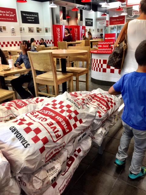 The Real Reason You Always See Bags Of Potatoes Inside Five Guys