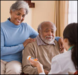 Photo: A man and woman talking with a healthcare professional