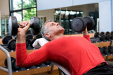 A man lifts weights at the gym