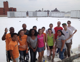 NYC Coolroofs volunteers coating a rooftop