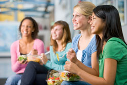 photo of girls eating salad