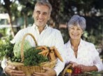 Older couple with baskets of fruit and vegetables