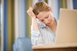 Tired woman with laptop computer