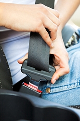 Girl buckling seatbelt
