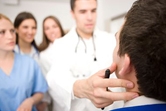 Doctor checking a patient's neck