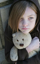 Sad child with her teddy bear