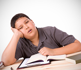 Child falling asleep at his desk