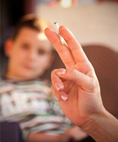 Child watches his parent smoke