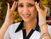 Woman shows pain from a headache