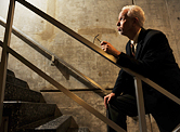 A man out of breath struggling to get upstairs