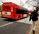 A man runs to catch the bus - Credit: Photo by Chris Smith