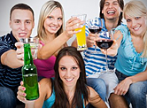 Teenagers holding up their glasses at a party