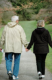 Two older people walking together