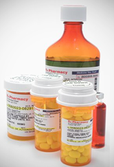 Four prescription drug bottles filled up