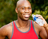 Man working out drinks water.