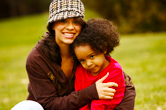A mom hugs her daughter.