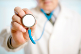 A doctor holds a stethoscope.