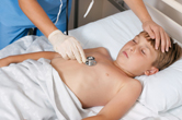 A young boy has his lungs checked.