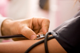 A person has their blood pressure checked.