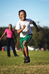 A young boy runs in a park.