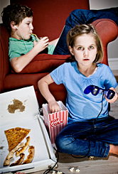 A young girl and boy in front of the TV. 
