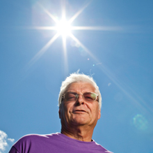 Photo of older man with blazing sun.